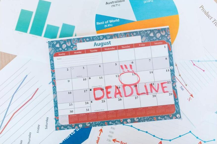 A calendar with a deadline circled in red marker on a desk