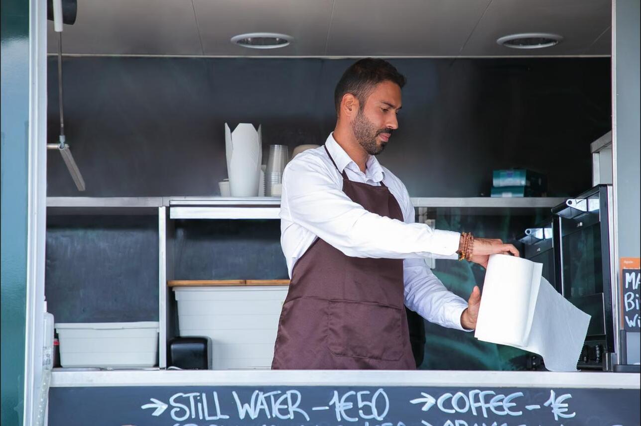 Small business owner running his food truck